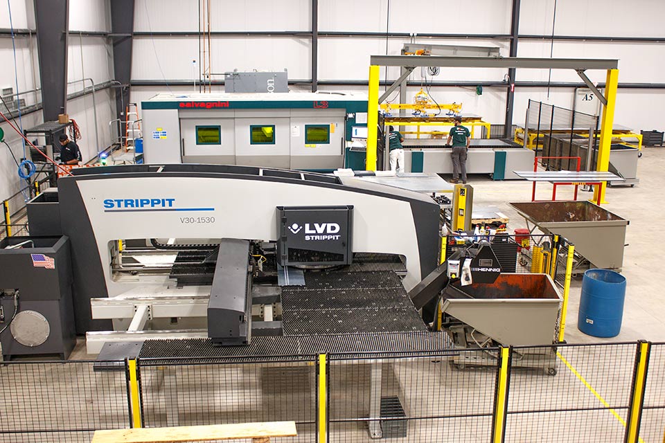 An Ajax CNC turret press and fiber laser with gantry and vacuum sheet lifter.