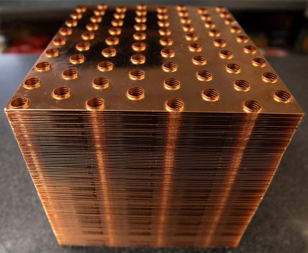 A stack of custom fin plates formed from very thin copper.