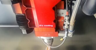 A fiber optic laser cutting head at Ajax Metal Forming Solutions