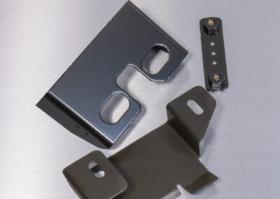 Laser Cut and formed metal part w/black painted finish manufactured by Ajax.