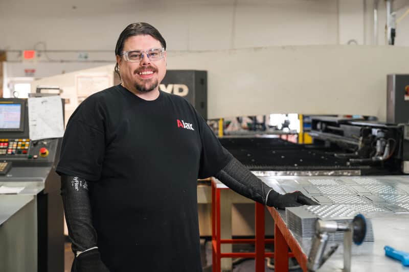 Ajax colleague Charles operates a CNC turret punch press.