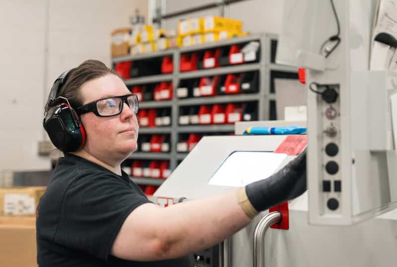 An Ajax toolroom colleague operates a Haas lathe.